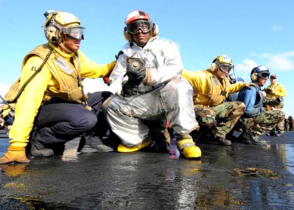 US Navy 090722-N-1062H-014 Sailors brace for shock while fighting a simulated fire during a general quarters drill aboard the aircraft carrier USS George Washington (CVN 73)