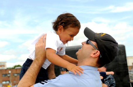 US Navy 090722-N-8467N-006 Culinary Specialist 1st Class Joseph Appold hugs his 1-year-old son Kameron upon the return of the Virginia-class attack submarine USS New Hampshire (SSN 778) to Submarine Base New London