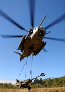 US Navy 090719-N-0120A-331 An MH-53E Sea Stallion helicopter, assigned to the Air Combat Element of the 31st Marine Expeditionary Unit, embarked aboard the forward-deployed amphibious assault ship USS Essex (LHD 2) lifts an M77