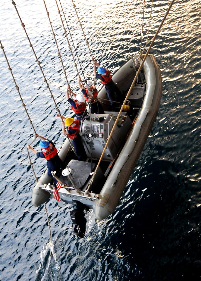 US Navy 090721-N-1644H-023 Sailors from USS George Washington's Deck Department pull on the manropes to raise the port side rigid hull inflatable boat