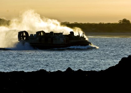 US Navy 090723-N-5253W-160 Landing Craft, Air Cushion (LCAC) 21, assigned to Assault Craft Unit (ACU) 5, transports U.S. Marines and vehicles from the beach