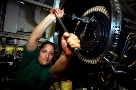 US Navy 090721-N-3610L-375 Aviation Machinist Mate 3rd Class Amanda Oterocastillo tightens a bolt on a jet engine in the jet shop aboard the aircraft carrier USS Ronald Reagan (CVN 76)