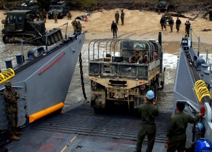 US Navy 090722-N-6692A-037 Sailors guide a truck from the 31st Marine Expeditionary Unit (31st MEU) onto Landing Craft Utility (LCU) 1627 as Marines disembark for the field training part of military exercise Talisman Saber 2009