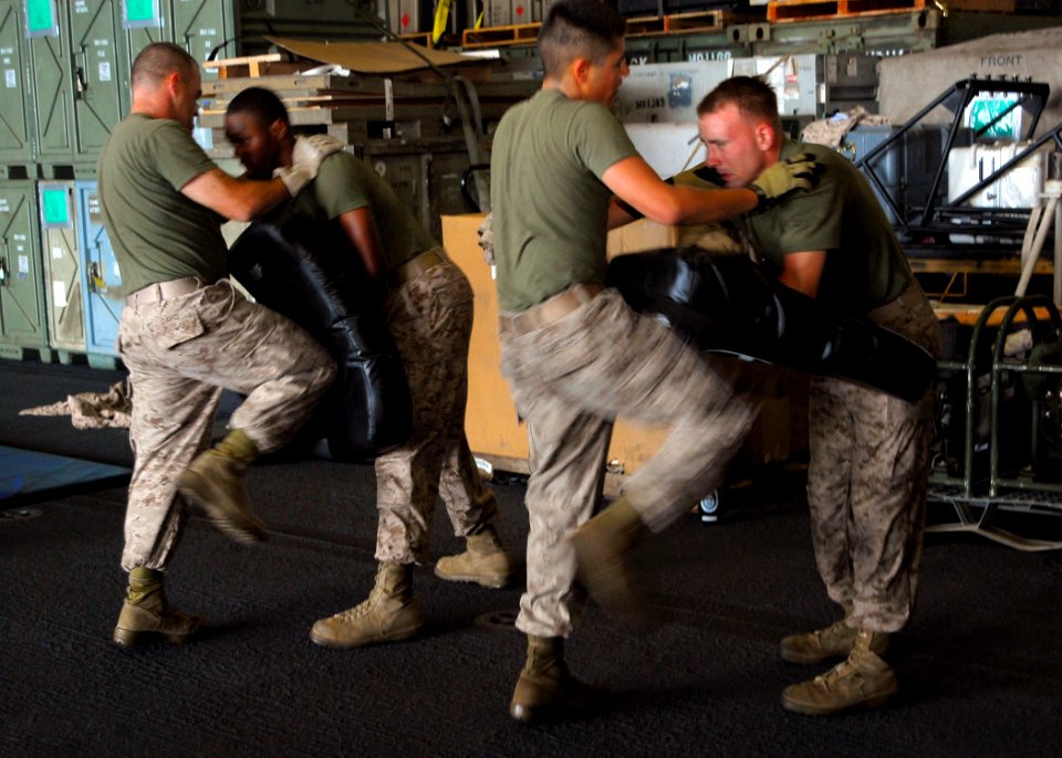 US Navy 090722-N-8607R-090 Marines attached to Combat Logistics Battalion (CLB) 11 practice proper fighting techniques of the Marine Corps Martial Arts Program in the hangar bay of the amphibious assault ship USS Bonhomme Richa