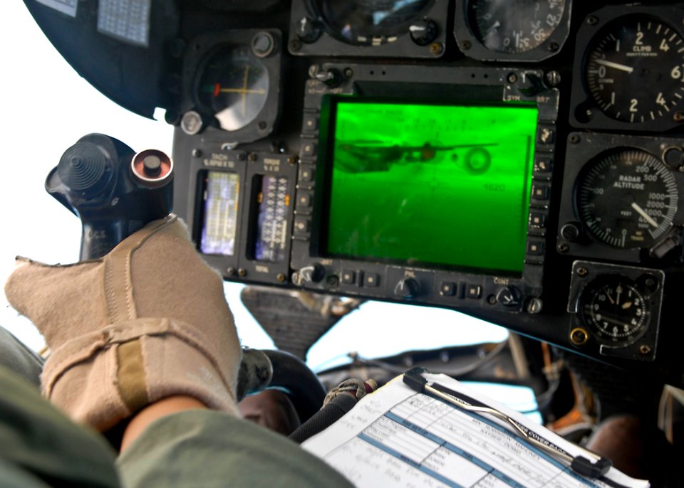 US Navy 090721-N-9950J-547 Marine Capt. Erick Min, assigned to Marine Medium Helicopter Squadron Two Six Two (HMM-262), pilots a CH-53E Sea Stallion helicopter during an in-flight refueling with an Air Force KC-130