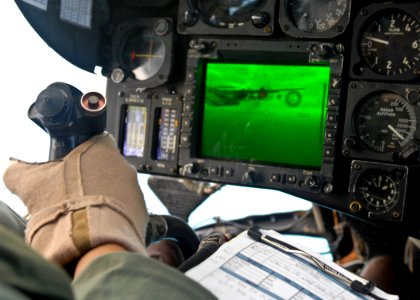 US Navy 090721-N-9950J-547 Marine Capt. Erick Min, assigned to Marine Medium Helicopter Squadron Two Six Two (HMM-262), pilots a CH-53E Sea Stallion helicopter during an in-flight refueling with an Air Force KC-130
