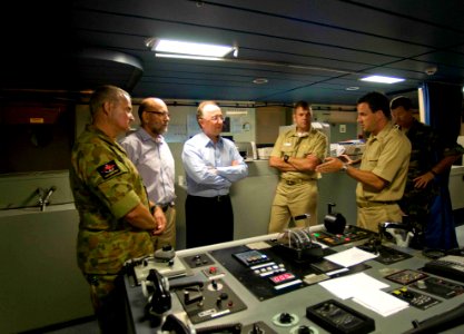 US Navy 090720-N-9689V-013 Capt. Jonathan Olmstead, ship's master of the Military Sealift Command dry cargo-ammunition ship USNS Richard E. Byrd (T-AKE 4), explains aspects of the ship's bridge to Australian High Commissioner t