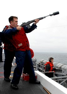 US Navy 090724-N-2600H-009 Gunners Mate 3rd Class Nathan Brassmassery fires a shot line from the flight deck of the aircraft carrier USS Nimitz (CVN 68) to the Military Sealift Command fleet replenishment oiler USNS Yukon (T-AO