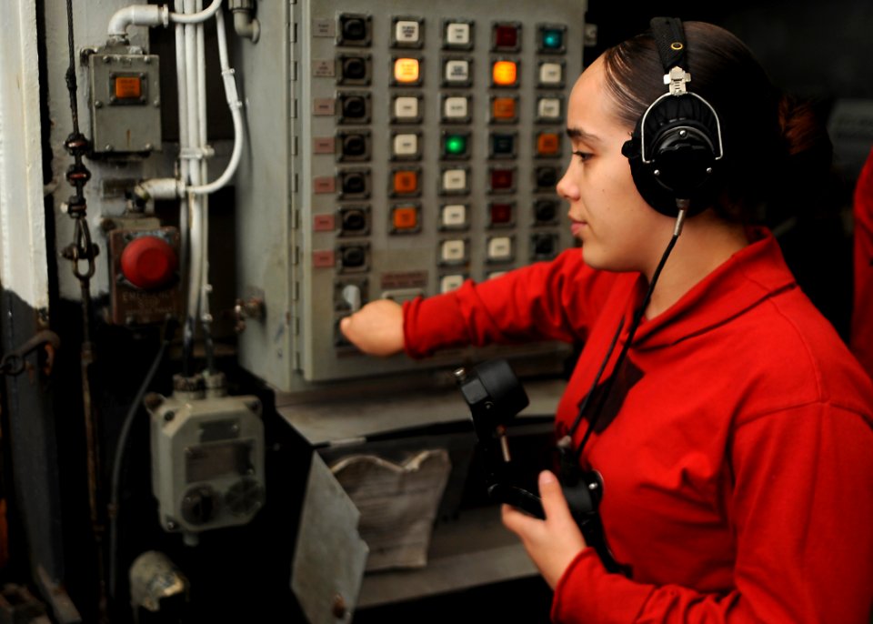 US Navy 090722-N-9988F-030 Aviation Ordnanceman Airman Jessica Torres closes a weapons elevator containing ordnance support equipment aboard the Nimitz-class aircraft carrier USS Dwight D. Eisenhower (CVN 69)