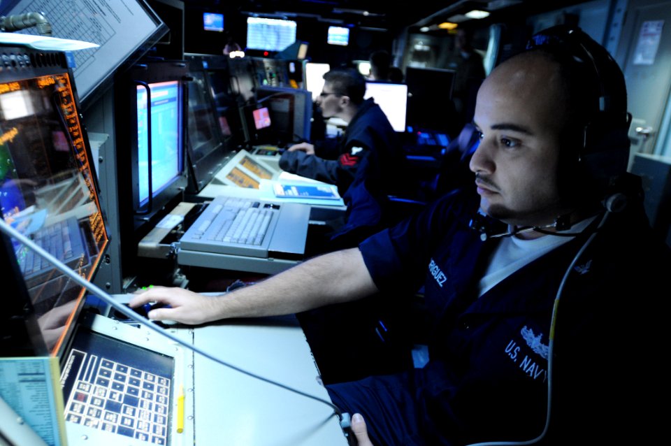 US Navy 090722-N-4995K-037 Operations Specialist 1st Class Eric Rodriguez stands the tactical information coordinator watch in the Combat Direction Center (CDC) aboard the aircraft carrier USS Ronald Reagan (CVN 76)
