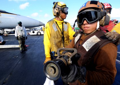 US Navy 090722-N-1062H-017 Aviation Machinist's Mate Airman David Vang fights a simulated fire aboard the aircraft carrier USS George Washington (CVN 73)