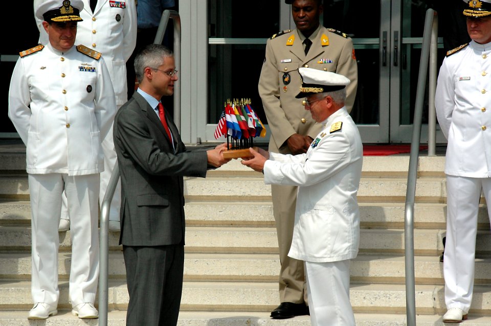 US Navy 090721-N-2386B-002 Deputy Supreme Allied Commander Transformation, Italian Navy Adm. Luciano Zappata (right), presents at gift to most honored guest, Belgium Minister Counselor