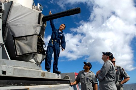 US Navy 090723-N-9123L-054 Fire Controlman 2nd Class Chaung Pha of Sacramento, Calif. explains functions of guided-missile destroyer USS McCampbell's (DDG 85) Close-In Weapons System to Royal Australian Navy sailors
