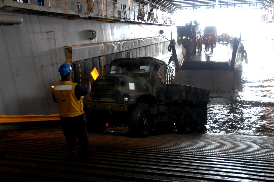 US Navy 090725-A-1839I-013 Seaman Tyree Evans directs a Marine as he drives a vehicle onto a Brazilian Navy Landing Craft