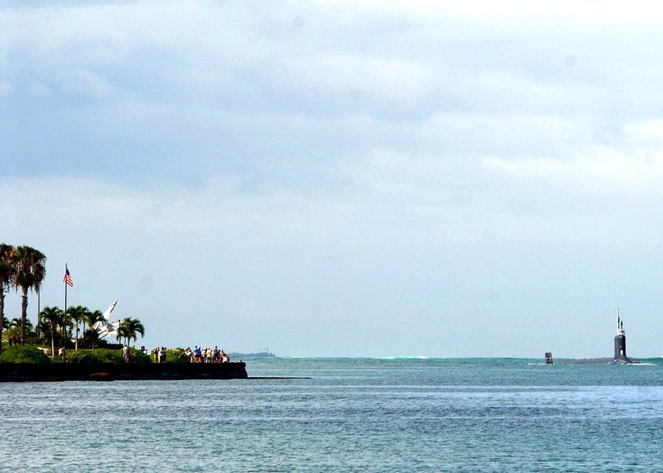 US Navy 090723-N-5476H-085 Friends and family members gather along the shoreline to welcome the Virginia-class attack submarine USS Hawaii (SSN 776) as it enters the channel to Pearl Harbor
