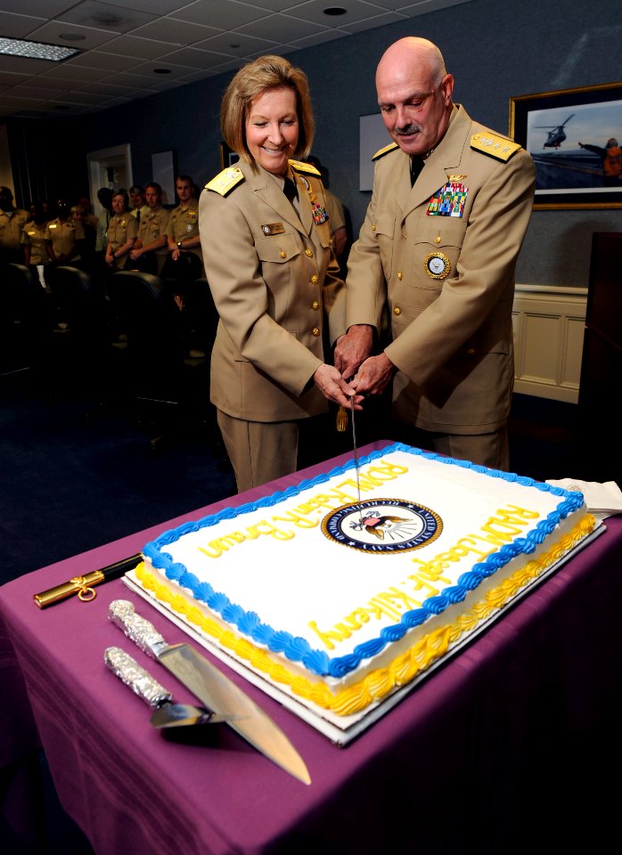 US Navy 090723-N-0555B-472 Rear Adm. Robin Braun, left, and Rear Adm. Joseph Kilkenny, right, cut a cake at a reception following a change of command ceremony