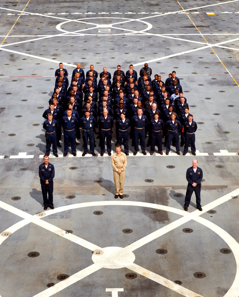 US Navy 090723-N-7090S-103 The first crew of the amphibious transport dock ship USS New York (LPD 21) stands in formation behind Cmdr. F. Curtis Jones, commanding officer, Cmdr. Erich B. Schmidt,