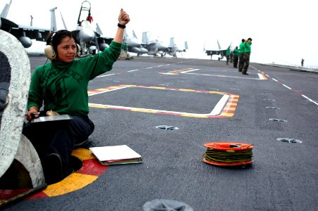 US Navy 090725-N-8960W-003 Aviation Boatswain's Mate Electrician 2nd Class Vianca Hernandez indicates catapult systems are ready to launch aircraft from the aircraft carrier USS Nimitz (CVN 68)