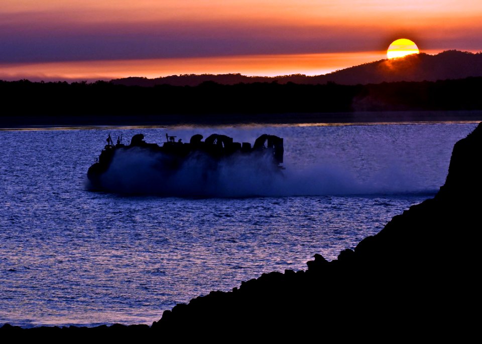 US Navy 090723-N-5253W-225 Landing Craft, Air Cushion (LCAC) 10, assigned to Assault Craft Unit (ACU) 5, makes a late-afternoon run to the beach while transporting U.S. Marines and vehicles back to the amphibious assault ship U