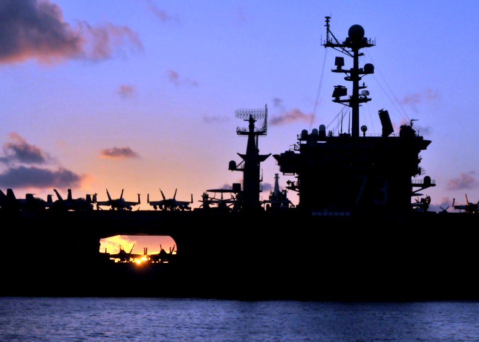 US Navy 090724-N-1644H-129 The aircraft carrier USS George Washington (CVN 73) is silhouetted as it transits the western Pacific Ocean at sunrise
