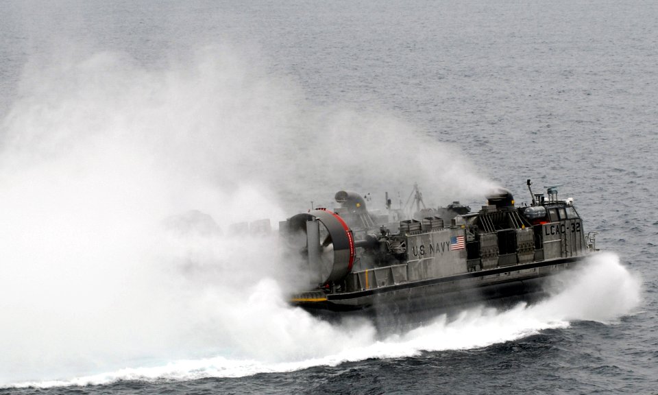 US Navy 090726-N-5148B-123 A landing craft air cushion (LCAC) assigned to Assault Craft Unit (ACU) 5 debarks the well deck of the amphibious dock landing ship USS Rushmore (LSD 47)