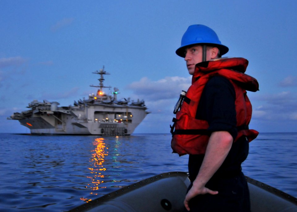 US Navy 090724-N-1644H-026 Boatswain's Mate 3rd Class Thomas McKiernan, assigned to the deck department aboard the aircraft carrier USS George Washington (CVN 73), prepares to approach the stern dock of George Washington in a r