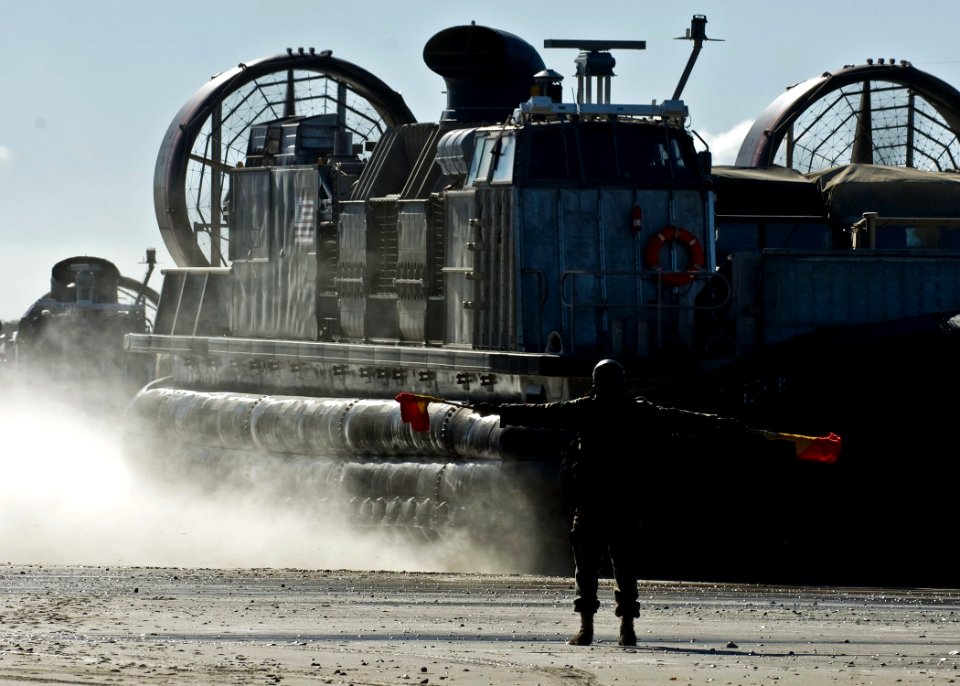 US Navy 090723-N-5253W-047 Seaman Nyja Allen, from New York assigned to Beach Master Unit (BMU) 1, directs Landing Craft Air Cushion (LCAC) 21