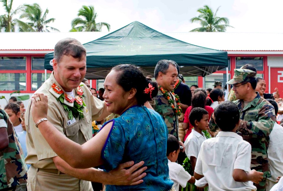 US Navy 090724-N-9689V-005 Capt. Andrew Cully, Pacific Partnership 2009 mission commander, dances with a local woman during a Pacific Partnership 2009 community service project at Faleloa Primary School