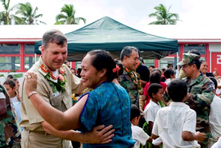 US Navy 090724-N-9689V-005 Capt. Andrew Cully, Pacific Partnership 2009 mission commander, dances with a local woman during a Pacific Partnership 2009 community service project at Faleloa Primary School photo