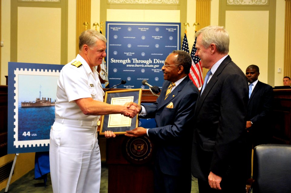US Navy 090727-N-8273J-054 Chief of Naval Operations (CNO) Adm. Gary Roughead, left, and Secretary of the Navy (SECNAV) the Honorable Ray Mabus, right, are presented a commemorative copy of the Congressional Remarks by Senator