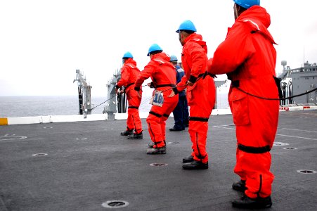 US Navy 090724-N-8960W-022 Sailors assigned to the deck department of the aircraft carrier USS Nimitz (CVN 68) heave in the phone and distance line in from the Fleet Replenishment Oiler USNS Yukon (T-AO 202)