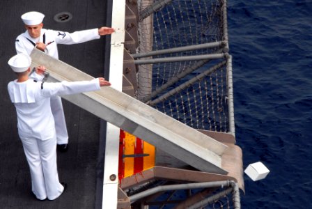 US Navy 090725-N-2918M-132 Religious Program Specialist 3rd Class Shawn Blankenship and Religious Program Specialist 3rd Class Matt Griffin commit remains to the sea during a burial-at-sea ceremony aboard the aircraft carrier US