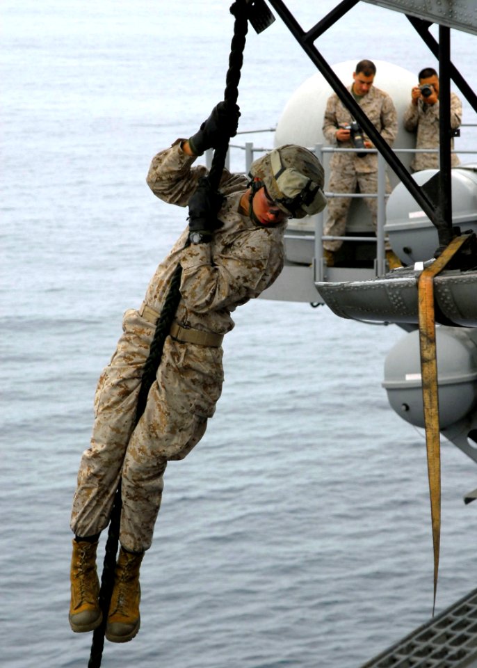 US Navy 090728-N-8607R-068 A Marine assigned to the 11th Marine Expeditionary Unit (11th MEU) fast-ropes out of a static CH-46E Sea Knight helicopter aboard the flight deck of USS Bonhomme Richard (LHD 6)