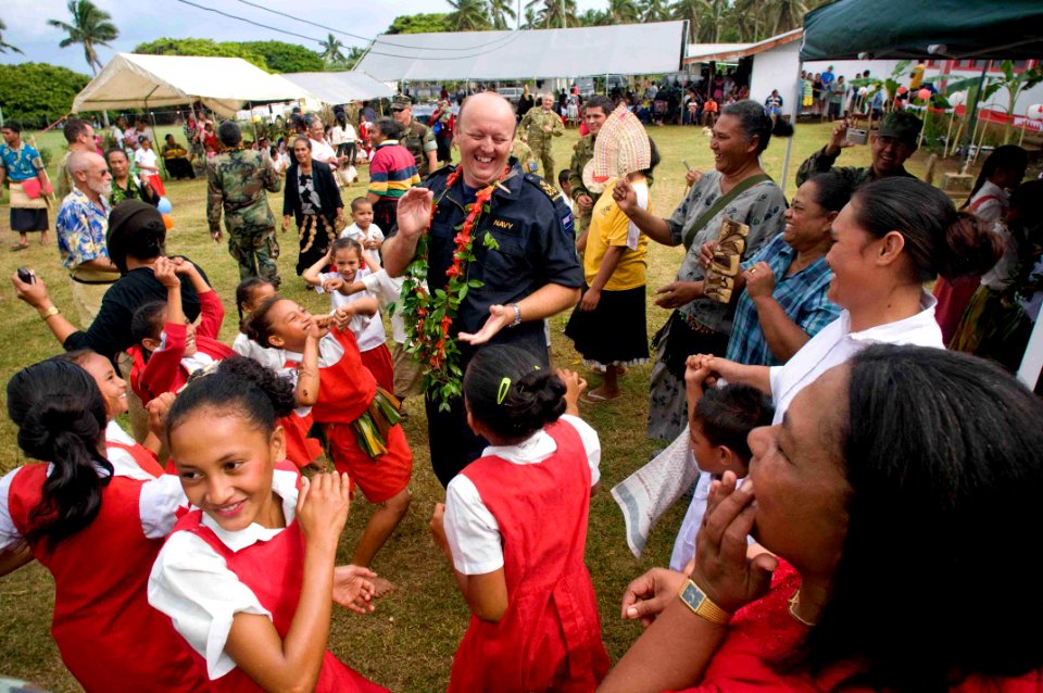 US Navy 090724-N-9689V-004 Royal New Zealand Navy Petty Officer Richard Boyd dances with school children during a Pacific Partnership 2009 community service project at Faleloa Primary School