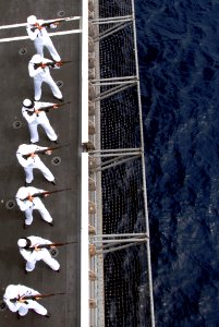 US Navy 090725-N-2918M-143 Sailors assigned to the weapons department of the aircraft carrier USS Nimitz (CVN-68) render a rifle salute during a burial-at-sea ceremony