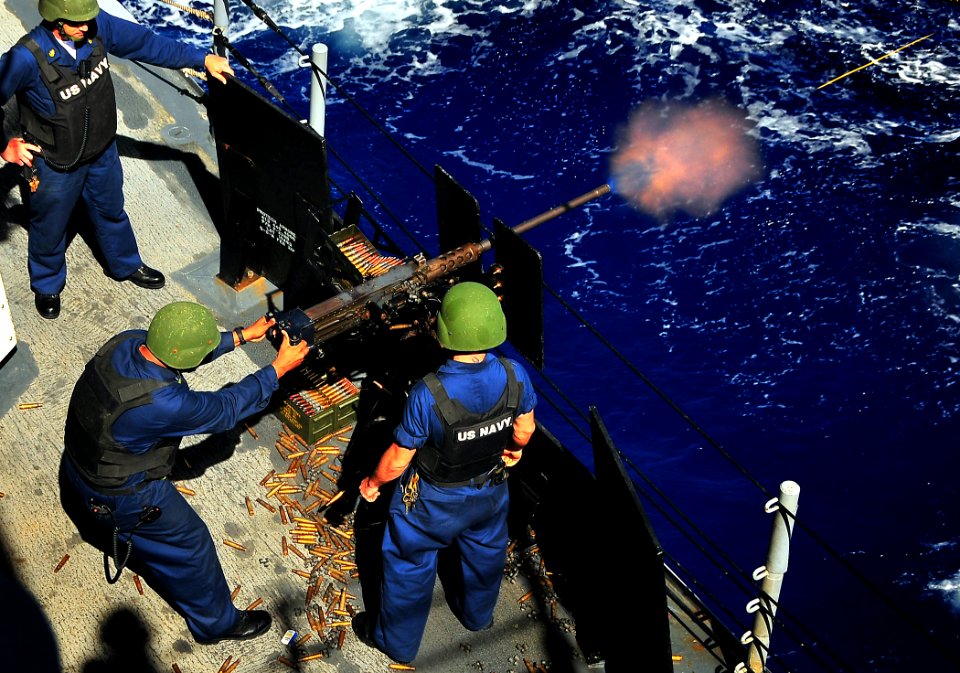 US Navy 090725-N-4774B-054 Gunners Mates aboard the guided-missile cruiser USS Lake Champlain (CG 57) fire a .50 caliber machine gun during a live-fire exercise