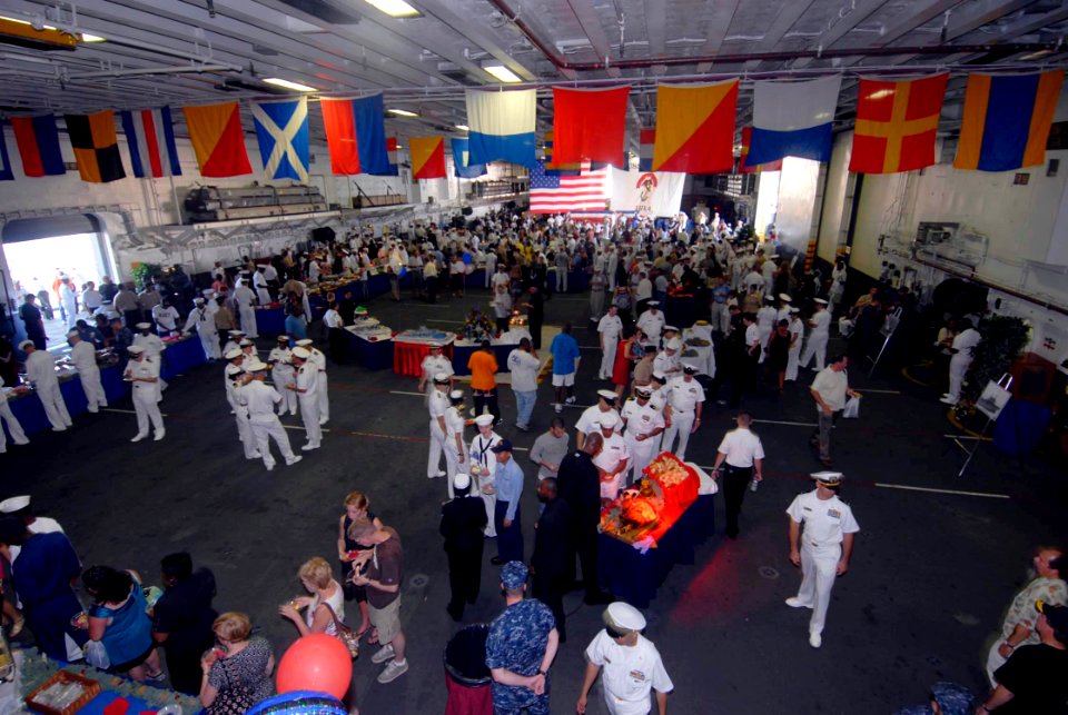 US Navy 090725-N-3592S-106 Crew members and visitors gather in the hangar bay of the amphibious assault ship USS Nassau (LHA 4) to celebrate the 30th anniversary of the ship's commissioning