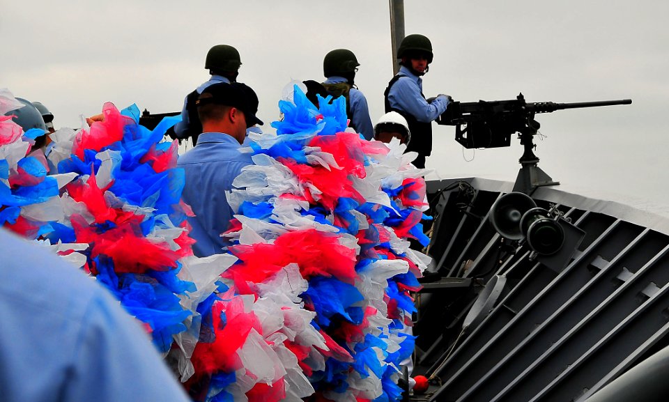 US Navy 090730-N-4774B-018 Sailors aboard the guided-missile cruiser USS Lake Champlain (CG 57) carry a large lei across the forecastle in preparation for the ship's homecoming