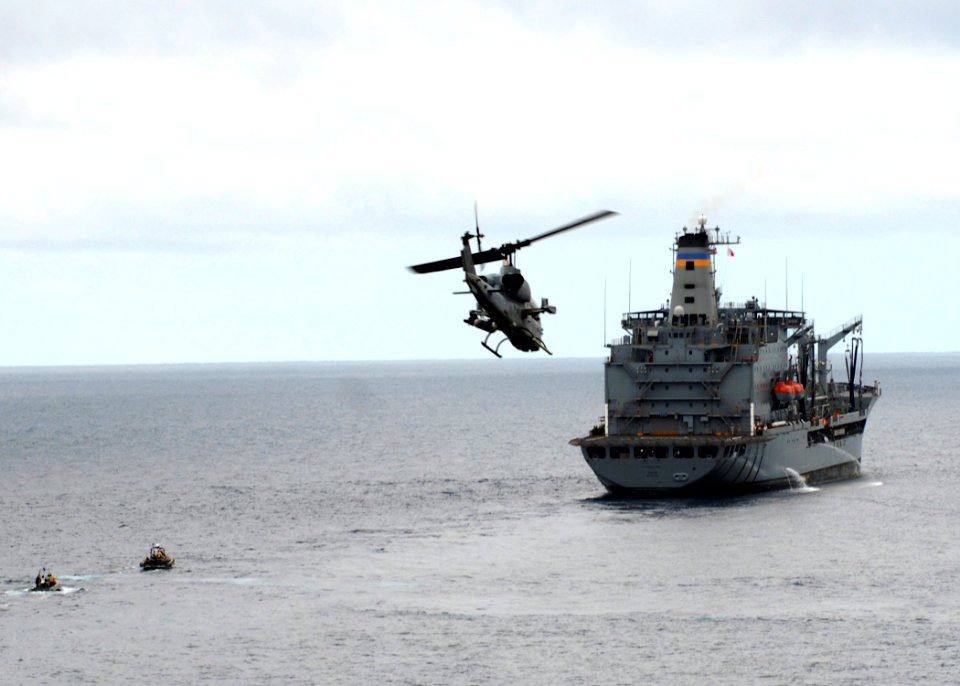 US Navy 090730-N-5148B-099 An AH-1W Super Cobra helicopter attached to Marine Medium Helicopter Squadron (HMM) 166 flies over the Military Sealift Command USNS Yukon (T-AO 202)