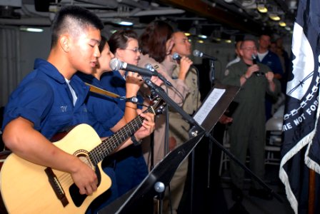 US Navy 090726-N-2918M-023 Aviation Boatswain's Mate (Fuel) Airman Loren Toy plays guitar during a Protestant religious service aboard the aircraft carrier USS Nimitz (CVN 68)