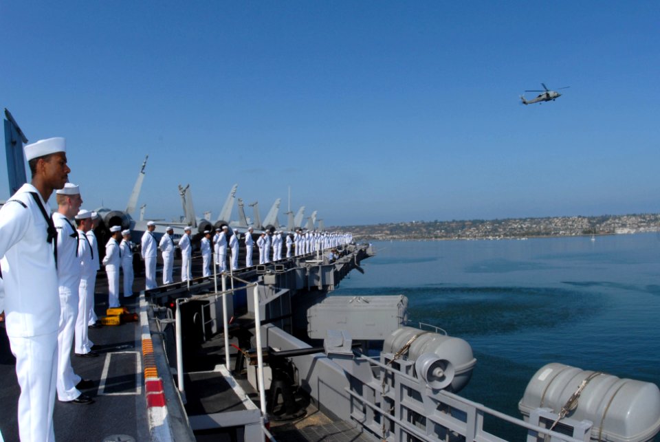 US Navy 090731-N-1786N-058 ailors aboard the aircraft carrier USS Nimitz (CVN 68) stand at parade rest while they man the rails