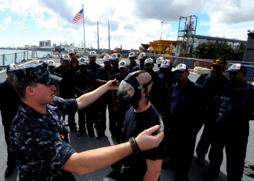 US Navy 090731-N-6138K-478 Damage Controlman 1st Class James Harry and Machinery Repairman 2nd Class James Porter, both assigned to the guided-missile destroyer USS Arleigh Burke (DDG 51), demonstrate the proper procedure for d