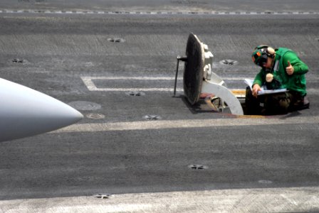 US Navy 090801-N-9132C-025 Aviation Boatswain's Mate (Equipment) 3rd Class James Deguise gives a thumbs up to acknowledge that the catapult is ready to launch an aircraft off of the flight deck of the aircraft carrier USS Ronal