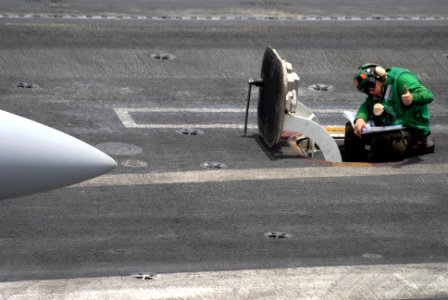 US Navy 090801-N-9132C-025 Aviation Boatswain's Mate (Equipment) 3rd Class James Deguise gives a thumbs up to acknowledge that the catapult is ready to launch an aircraft off of the flight deck of the aircraft carrier USS Ronal photo