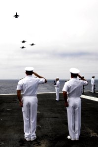 US Navy 090727-N-3038W-079 Capt. Michael Manazir, commanding officer of the aircraft carrier USS Nimitz (CVN 68) and Capt. Bret Batchelder, commander, Carrier Air Wing (CVW) 11, render salutes during a burial at sea