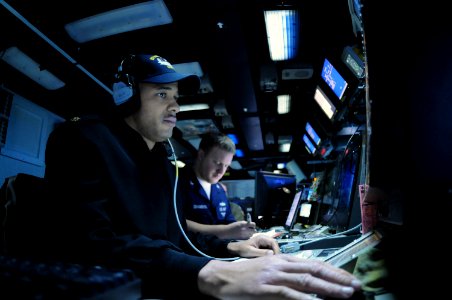 US Navy 090730-N-2344B-004 Lt. Cmdr. Willard Phillips, assistant combat direction center officer, mans the air defense warfare coordinator station in the Combat Direction Center aboard the aircraft carrier USS Ronald Reagan (CV