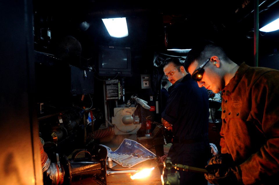US Navy 090801-N-2344B-119 Hull Maintenance Technician 3rd Class Carl Thompson modifies a shower mixer with an oxy-acetyl torch in the pipe shop aboard the aircraft carrier USS Ronald Reagan (CVN 76)