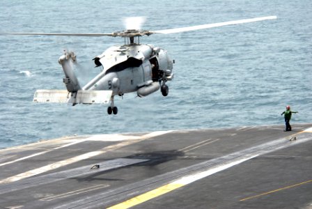 US Navy 090801-N-9132C-247 An HH-60H Sea Hawk assigned to the Black Knights of Helicopter Anti-Submarine Squadron (HS) 4 hovers above the flight deck of the aircraft carrier USS Ronald Reagan (CVN 76)
