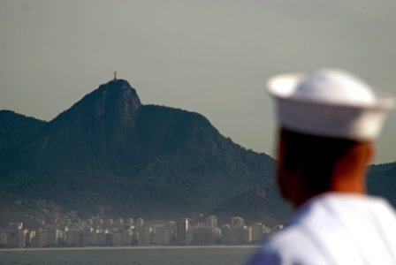 US Navy 090803-N-8878B-194 A Sailor aboard the amphibious assault ship pre-commissioning unit Makin Island (LHD 8) mans the rails while the ship pulls into Rio De Janeiro, Brazil photo