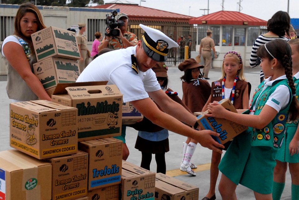 US Navy 090731-N-2918M-017 Lt. j.g. David helps San Diego Girl Scouts prepare for Operation Thin Mint as the aircraft carrier USS Nimitz (CVN 68) prepares to depart for a scheduled deployment to the western Pacific Ocean